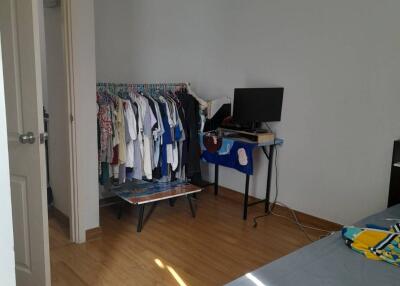 Bedroom with clothes rack and TV