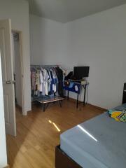 Bedroom with clothes rack and TV