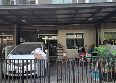 Front view of a residential building with a covered carport