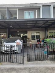 Front view of a residential building with a covered carport