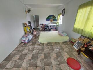 Bedroom with tiled floor, bed, and various items