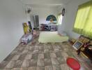 Bedroom with tiled floor, bed, and various items