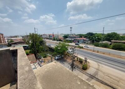 View from a building showcasing a busy road and nearby structures