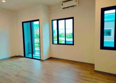 Spacious and bright living room with large windows and balcony access