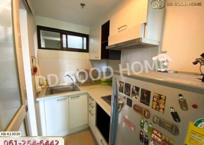 Compact modern kitchen with built-in appliances and ample storage