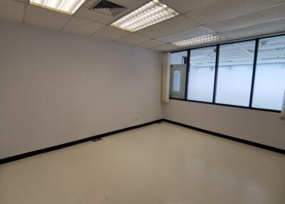 Empty office space with large windows