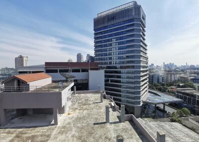 View of neighboring buildings and city skyline from the rooftop