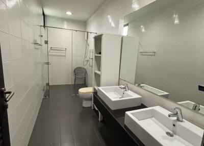 Modern bathroom with dual sinks and walk-in shower