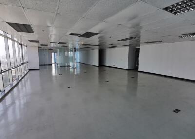 Spacious empty office space with large floor-to-ceiling windows