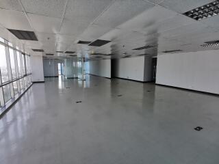 Spacious empty office space with large floor-to-ceiling windows