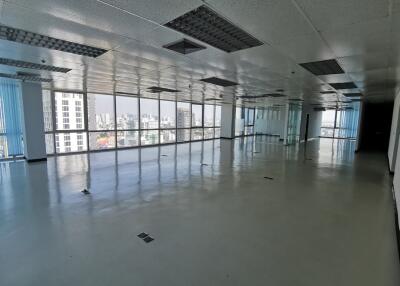 Spacious office area with large windows and city view