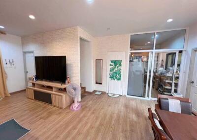 Spacious living room with entertainment center and dining area