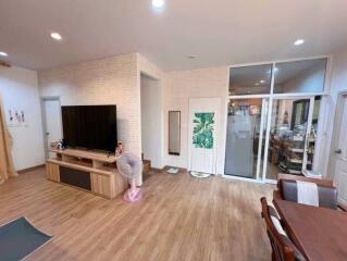 Spacious living room with entertainment center and dining area