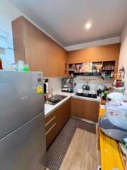 Modern kitchen with wooden cabinets and stainless steel appliances