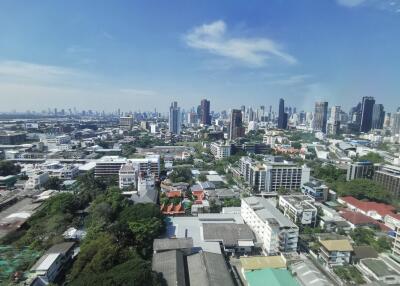 City skyline view with various buildings and vegetation