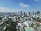 City skyline view with various buildings and vegetation