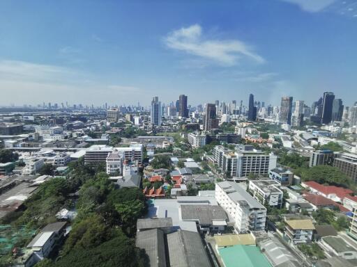 City skyline view with various buildings and vegetation