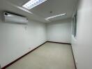 Empty room with tiled flooring and air conditioning