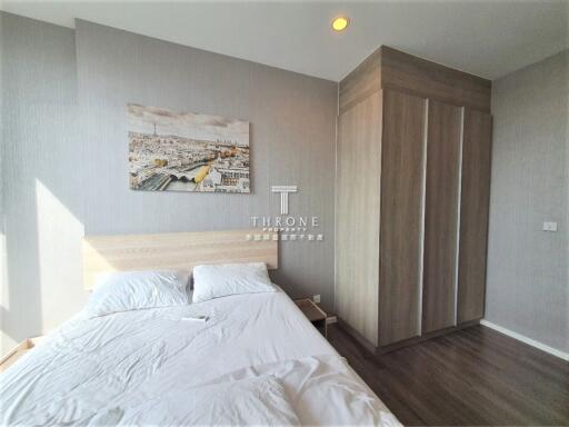 Bedroom with double bed, built-in wardrobe, and large window