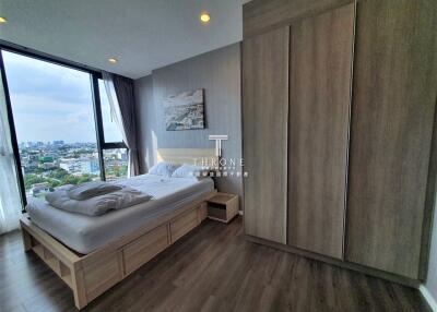 Modern bedroom with large window and city view