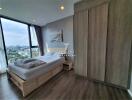 Modern bedroom with large window and city view