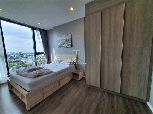 Modern bedroom with large window and city view