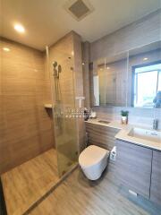 Modern bathroom with shower, toilet, and vanity unit