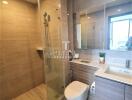 Modern bathroom with shower, toilet, and vanity unit