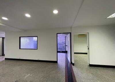 Interior of a commercial or residential space with rooms and windows.