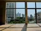 Spacious living room with large windows and city view