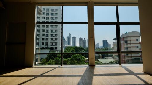 Spacious living room with large windows and city view