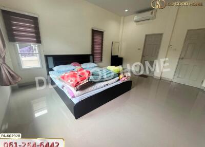 Spacious bedroom with bed and air conditioner