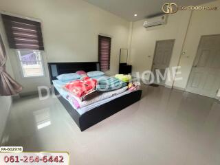 Spacious bedroom with bed and air conditioner