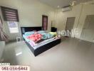 Spacious bedroom with bed and air conditioner