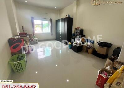 Spacious bedroom with large window and organizational storage