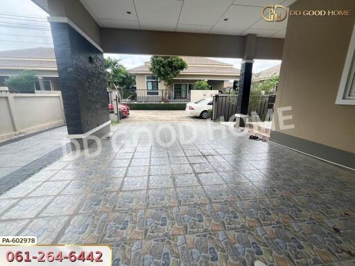 Covered garage area with paved floor and view of surrounding area