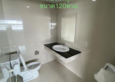 Modern bathroom with toilet, urinal, and sink