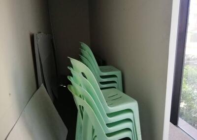 Storage area with stacked plastic chairs