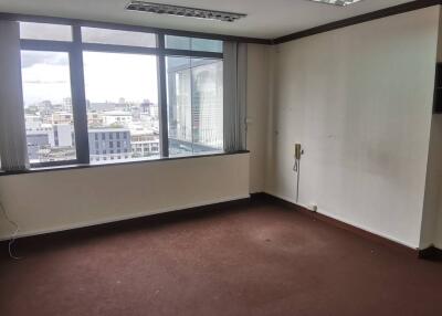 Empty office space with large window offering city views