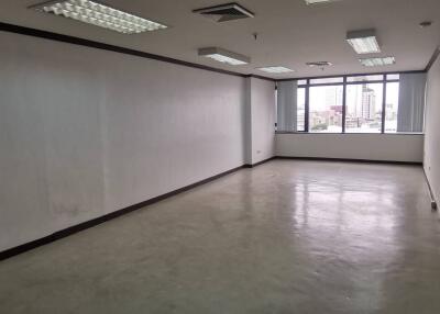 Empty office space with large windows