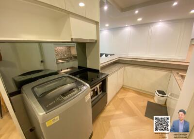 Modern laundry room with washing machine and ample counter space