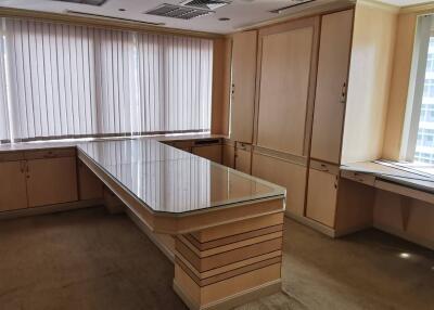 Modern office space with large glass table and ample storage