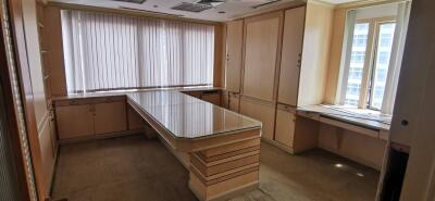 Modern office space with large glass table and ample storage