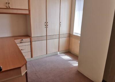 Small bedroom with built-in wardrobe and desk