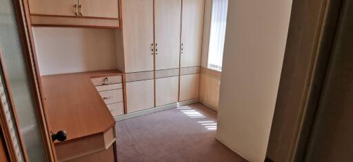 Small bedroom with built-in wardrobe and desk