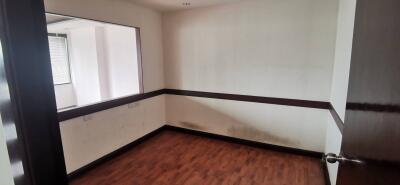 Unfurnished room with window and wooden floor