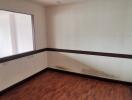 Unfurnished room with window and wooden floor