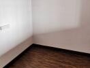 Empty bedroom with wooden floor