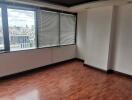 Spacious and empty living room with large windows