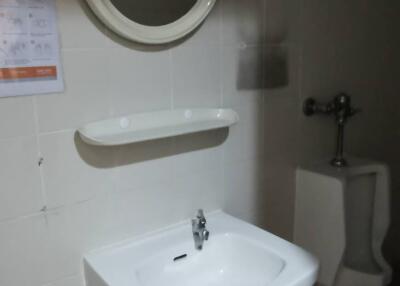 Bathroom with sink, mirror, and urinal